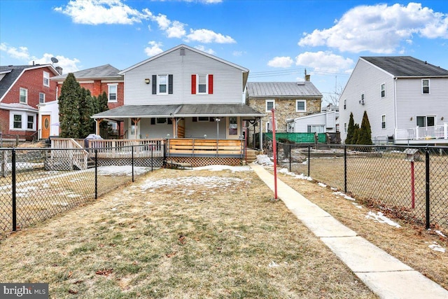 view of front facade featuring a porch, a residential view, a fenced backyard, and a front lawn