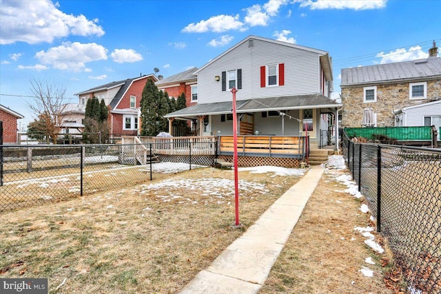 view of front of house featuring a porch, fence private yard, and a residential view