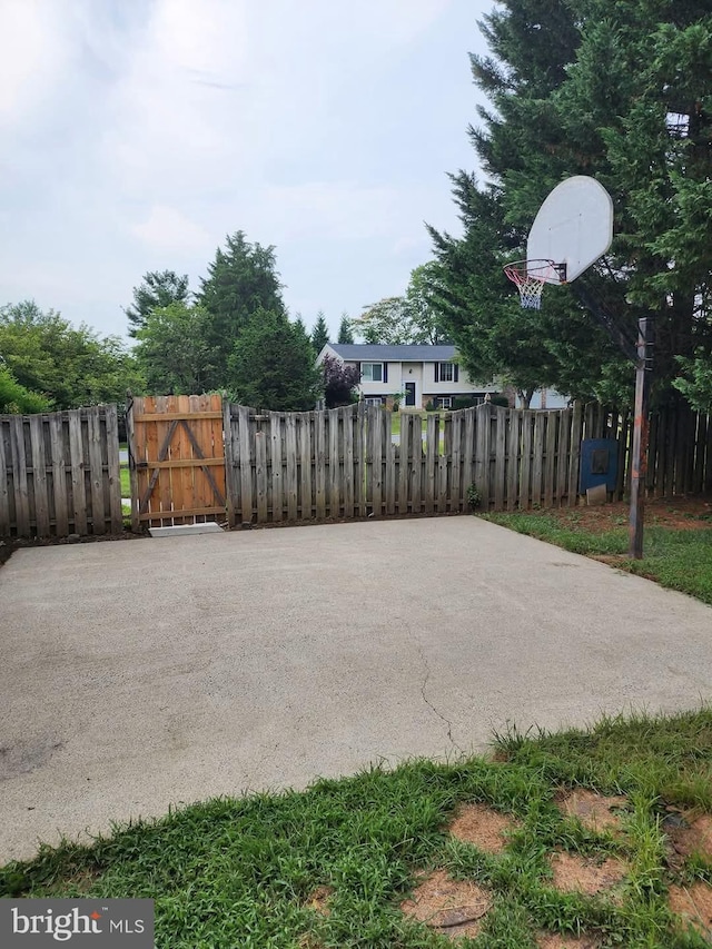 view of patio / terrace with fence, a gate, and basketball court