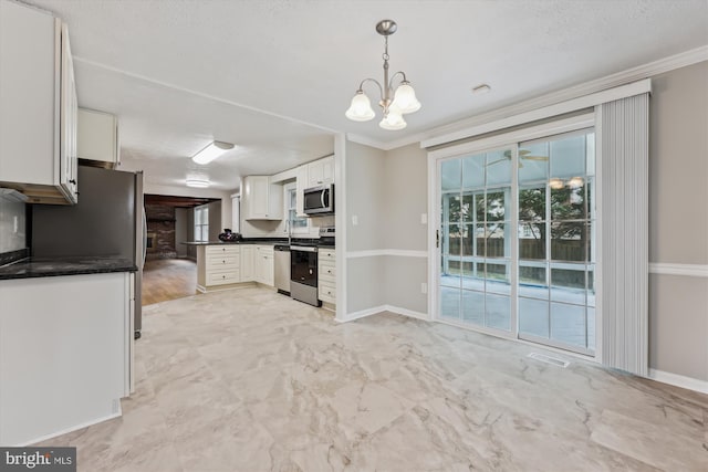 kitchen with stainless steel appliances, white cabinets, ornamental molding, dark countertops, and pendant lighting