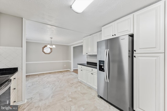 kitchen featuring decorative light fixtures, stainless steel appliances, dark countertops, white cabinets, and a textured ceiling