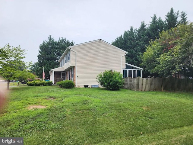 view of side of property featuring a yard and fence