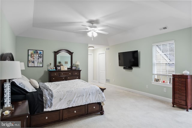 bedroom featuring a ceiling fan, visible vents, light carpet, and baseboards