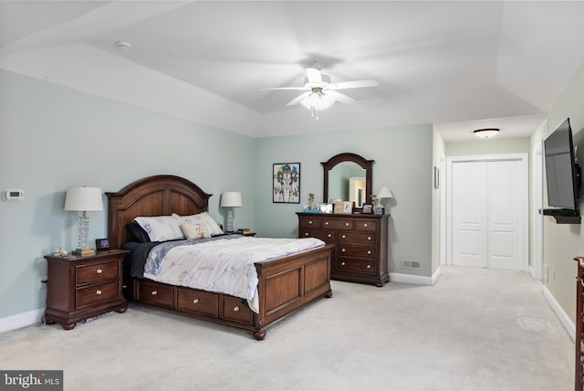 bedroom featuring lofted ceiling, a closet, light carpet, ceiling fan, and baseboards