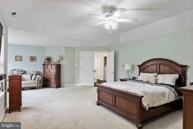 bedroom featuring baseboards, ceiling fan, visible vents, and light colored carpet