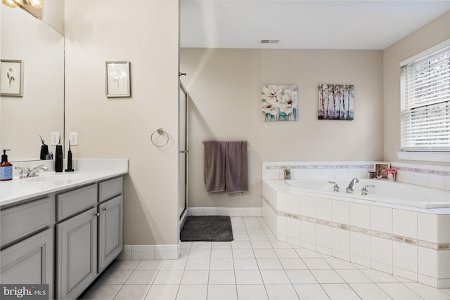 bathroom with a garden tub, tile patterned flooring, vanity, visible vents, and a stall shower