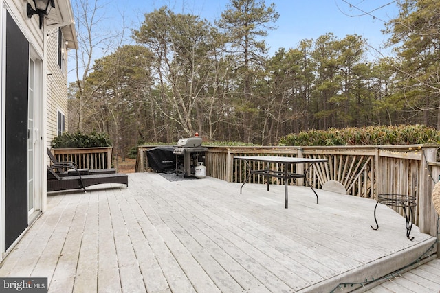 wooden terrace featuring a grill