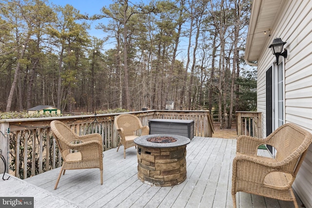 deck featuring an outdoor fire pit