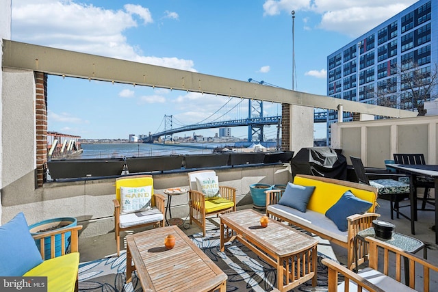 view of patio with a water view, an outdoor living space, and area for grilling