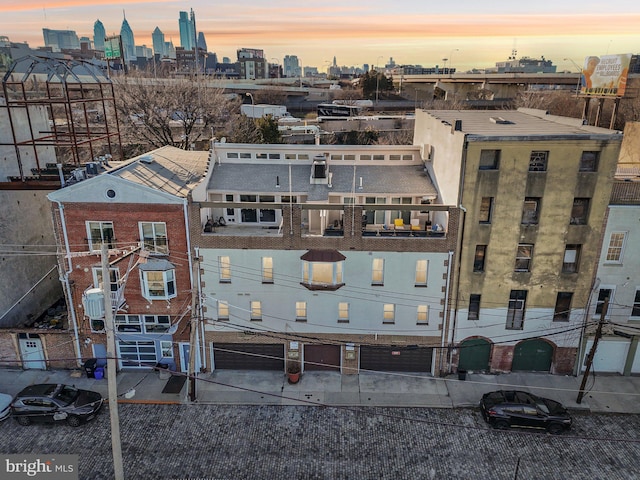 aerial view at dusk featuring a view of city