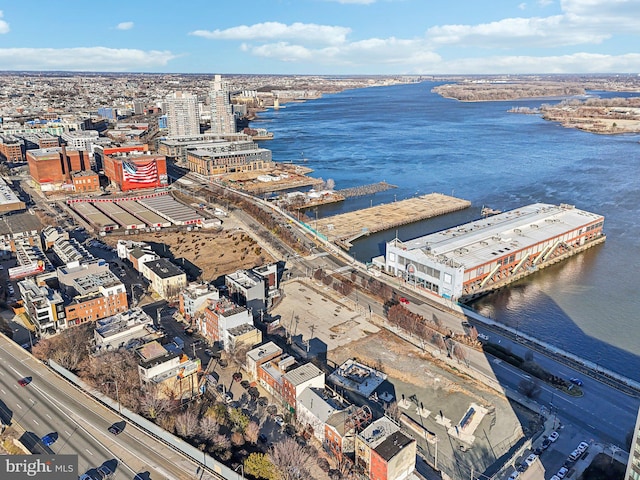 birds eye view of property with a water view and a city view