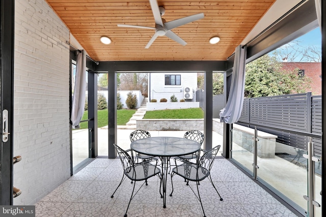 sunroom / solarium with a ceiling fan, lofted ceiling, and wood ceiling