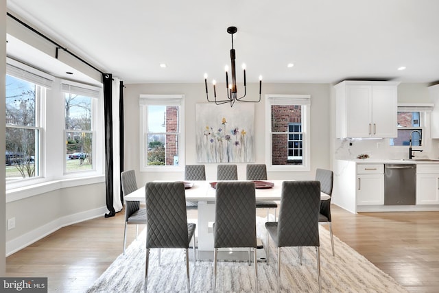 dining area with light wood-style floors, recessed lighting, and baseboards