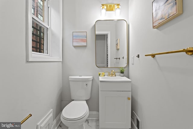 bathroom with visible vents, baseboards, toilet, marble finish floor, and vanity