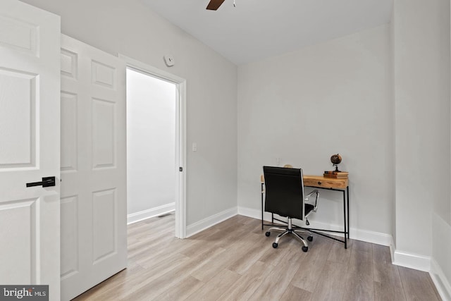 office with a ceiling fan, wood finished floors, and baseboards