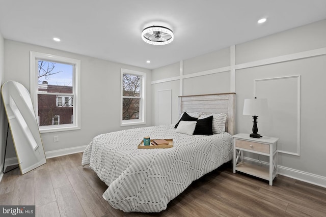 bedroom with recessed lighting, baseboards, and wood finished floors