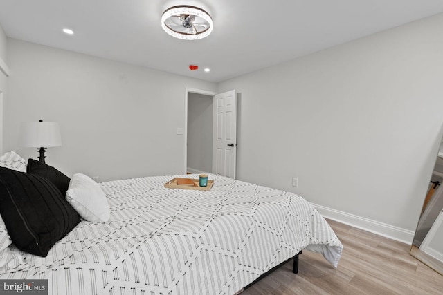 bedroom featuring recessed lighting, baseboards, and wood finished floors