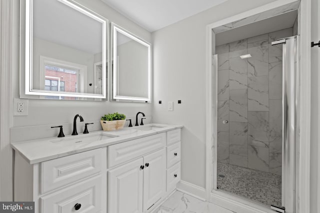 bathroom with marble finish floor, a marble finish shower, and a sink