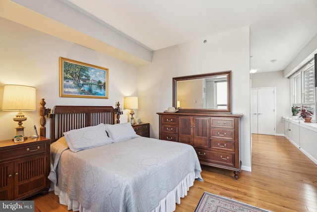 bedroom with baseboards and light wood finished floors