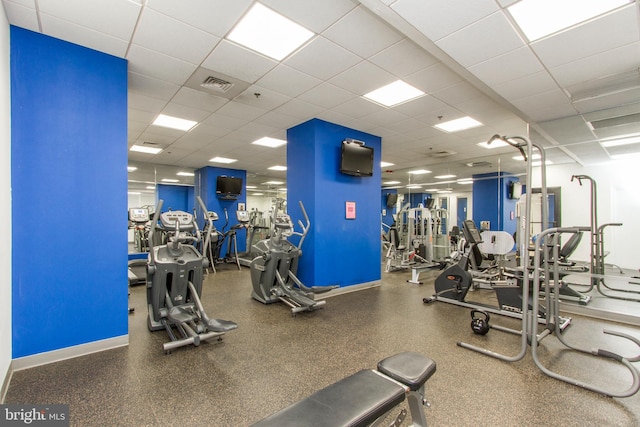 gym featuring a drop ceiling, visible vents, and baseboards