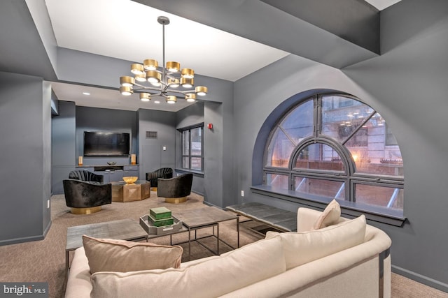 carpeted living area featuring a notable chandelier and baseboards