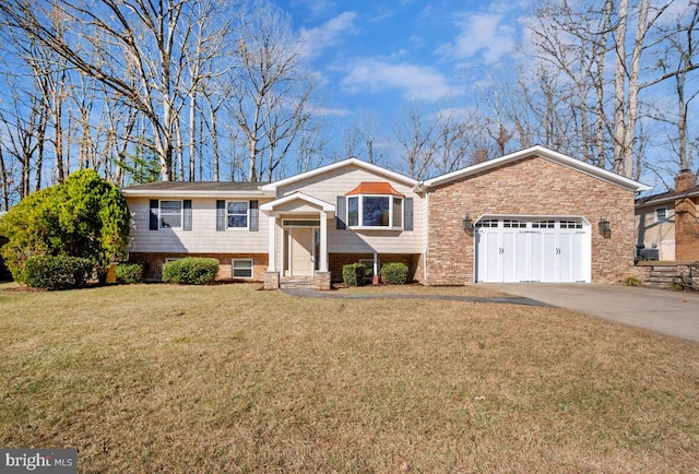 split foyer home featuring driveway, a front lawn, and an attached garage