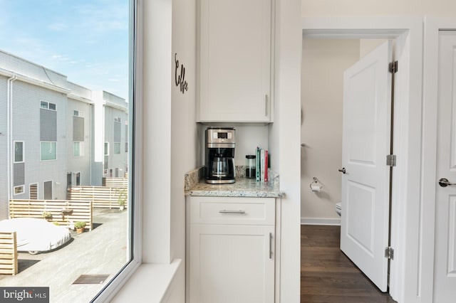 interior space featuring baseboards and dark wood finished floors