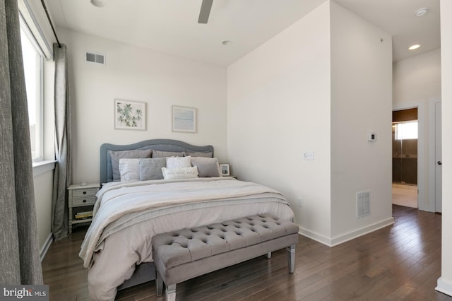 bedroom featuring visible vents, multiple windows, baseboards, and hardwood / wood-style floors