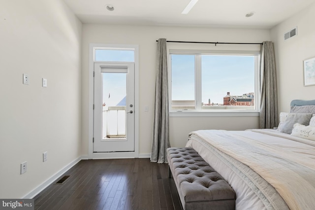 bedroom with visible vents, baseboards, and dark wood-style flooring