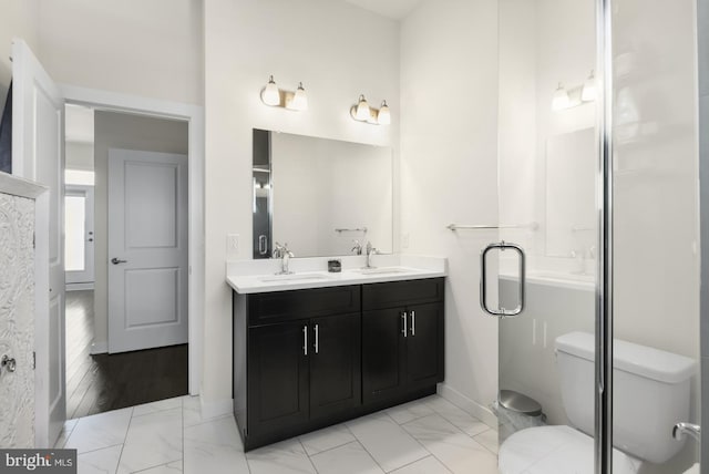 full bathroom featuring a sink, marble finish floor, and double vanity