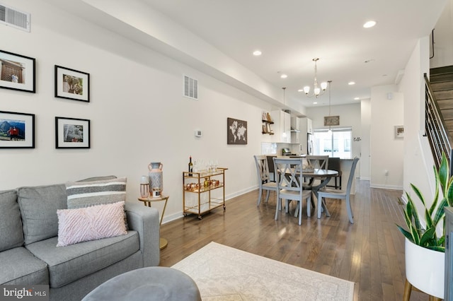 living room with visible vents, recessed lighting, stairs, and dark wood-style flooring