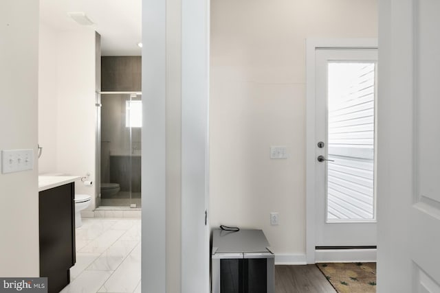 bathroom with vanity, a shower stall, toilet, and a wealth of natural light