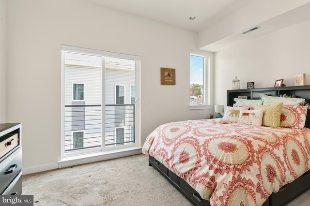 carpeted bedroom featuring visible vents and baseboards