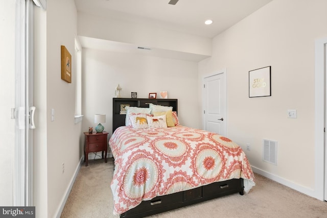 bedroom featuring baseboards, visible vents, and light carpet