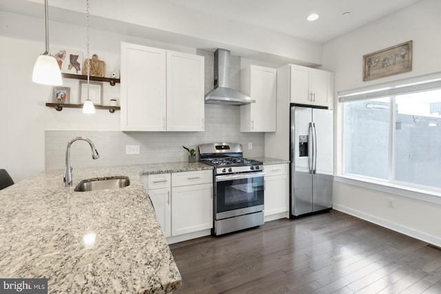 kitchen with tasteful backsplash, a sink, wall chimney range hood, stainless steel appliances, and open shelves