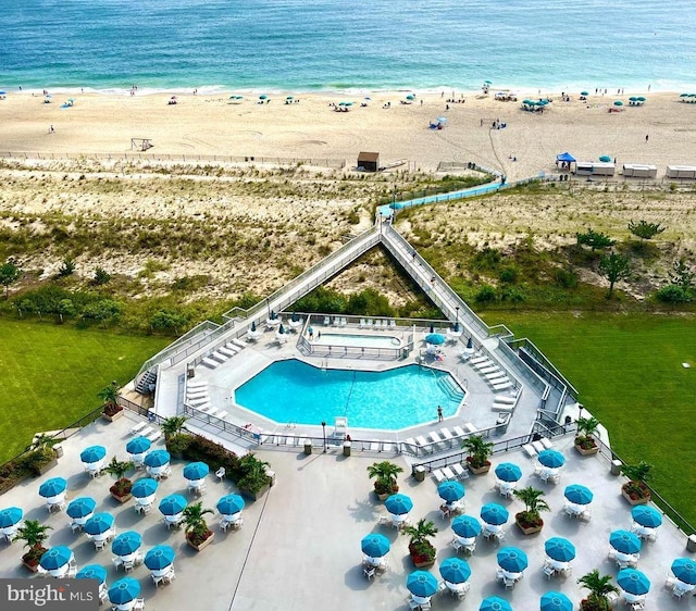 birds eye view of property with a water view and a view of the beach