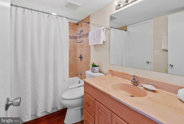 bathroom featuring hardwood / wood-style flooring, toilet, and vanity