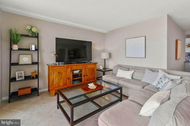 living room featuring light tile patterned flooring and a textured ceiling