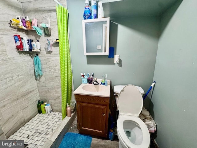 bathroom with toilet, vanity, and walk in shower