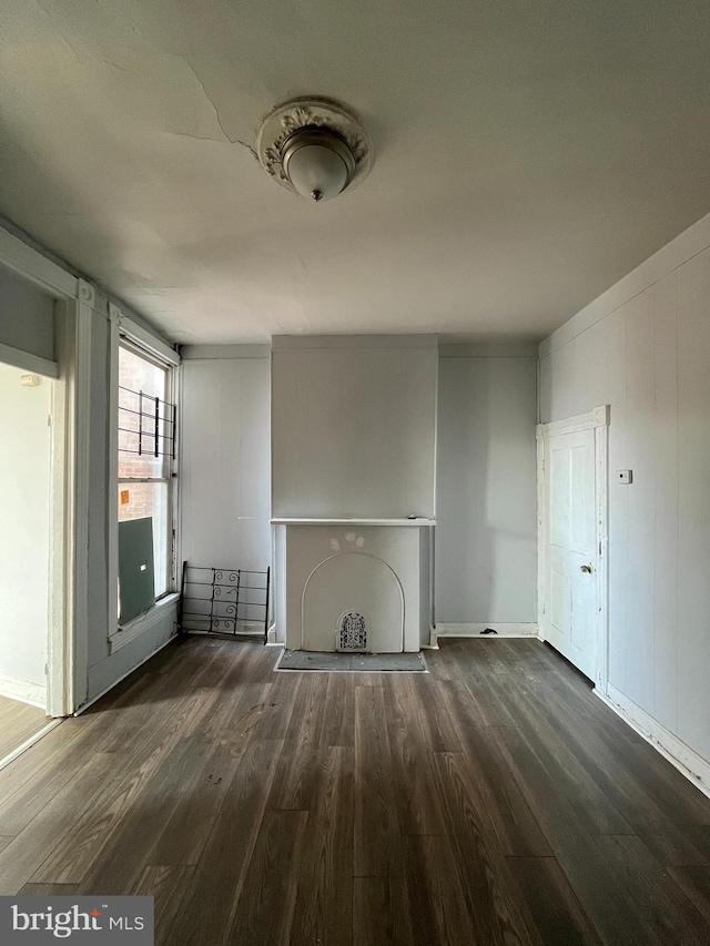 unfurnished living room with dark hardwood / wood-style floors