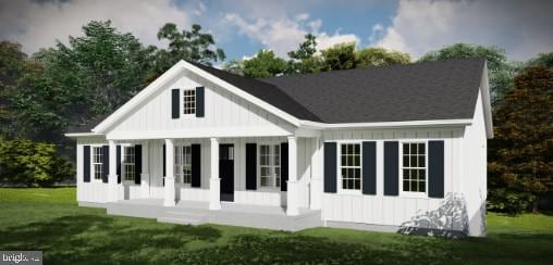 modern farmhouse with a porch, a front lawn, and board and batten siding