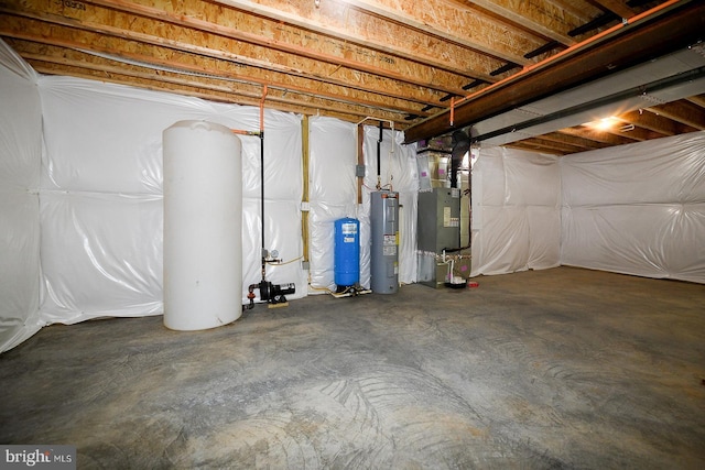 unfinished below grade area featuring heating unit and electric water heater