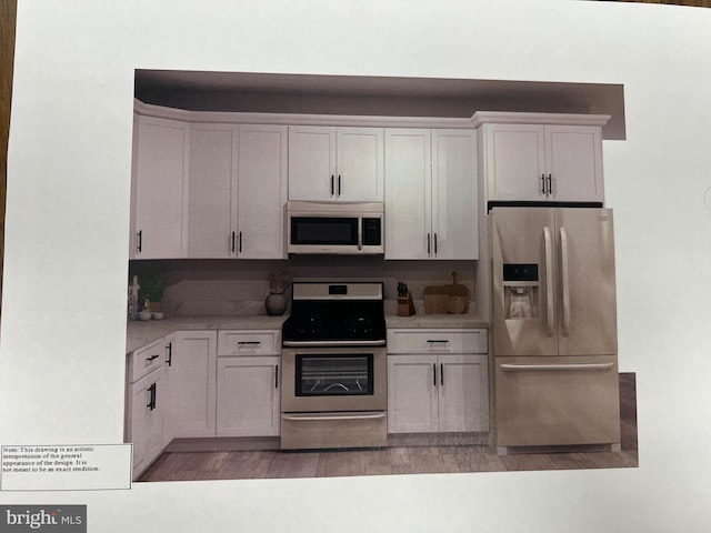 kitchen with light wood finished floors, white cabinetry, appliances with stainless steel finishes, and light countertops