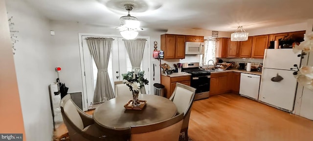 6689 Mackall, Saint Leonard, MD 20685 - kitchen featuring sink, white appliances, hanging light fixtures, and light hardwood / wood-style floors