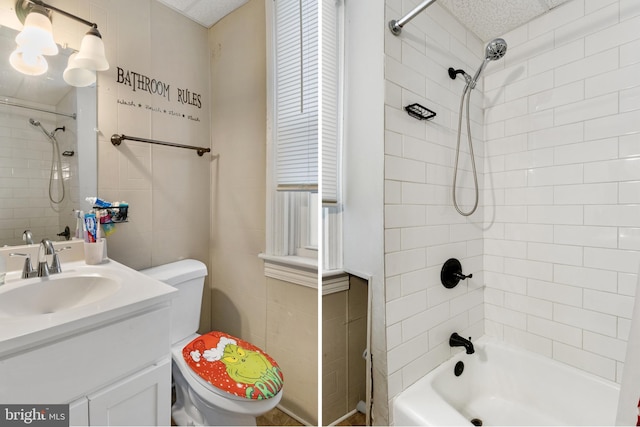 full bathroom featuring shower / bathing tub combination, vanity, toilet, and tile walls