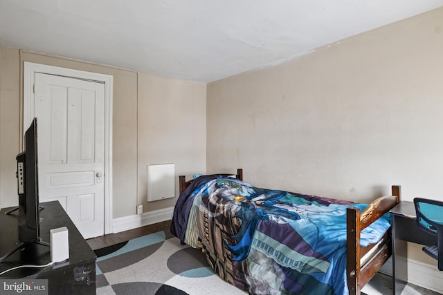 bedroom featuring dark wood finished floors and baseboards