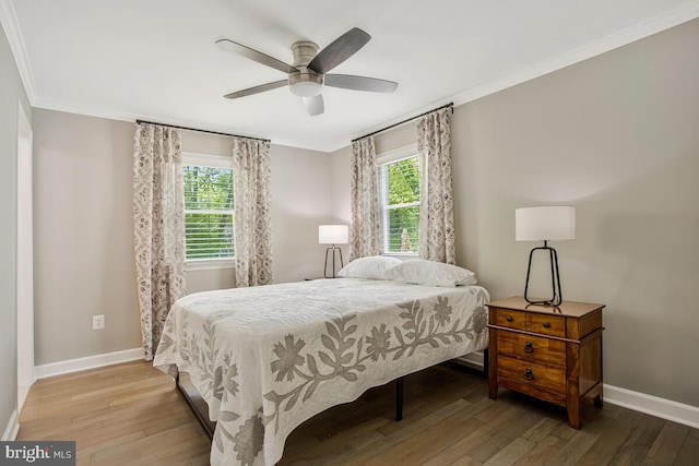 bedroom featuring baseboards, hardwood / wood-style flooring, a ceiling fan, and ornamental molding