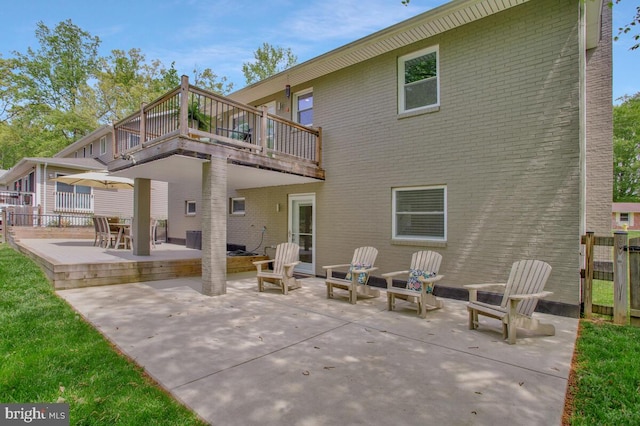 rear view of house featuring a patio area and brick siding