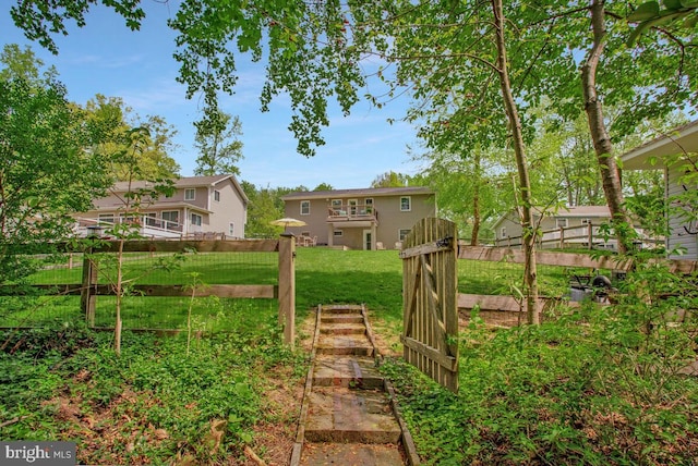 view of yard featuring fence and a garden