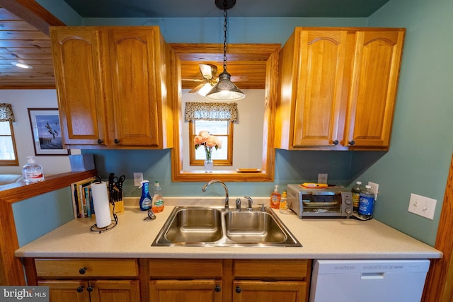 kitchen with decorative light fixtures, a healthy amount of sunlight, white dishwasher, and sink